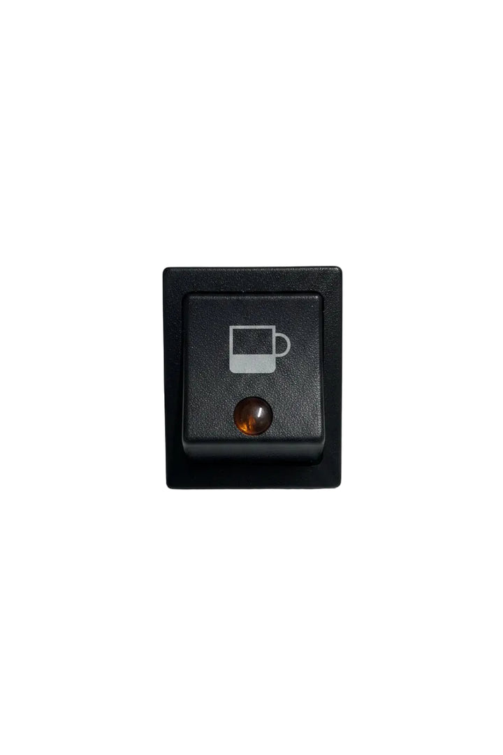 A black square rocker switch featuring a printed white coffee cup icon on the top half and a small amber indicator light on the bottom half, set against a plain off-white background.