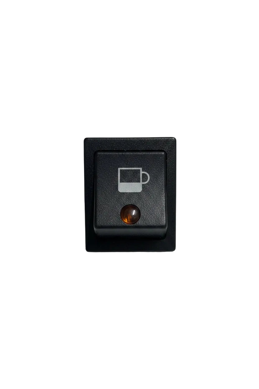 A black square rocker switch featuring a printed white coffee cup icon on the top half and a small amber indicator light on the bottom half, set against a plain off-white background.