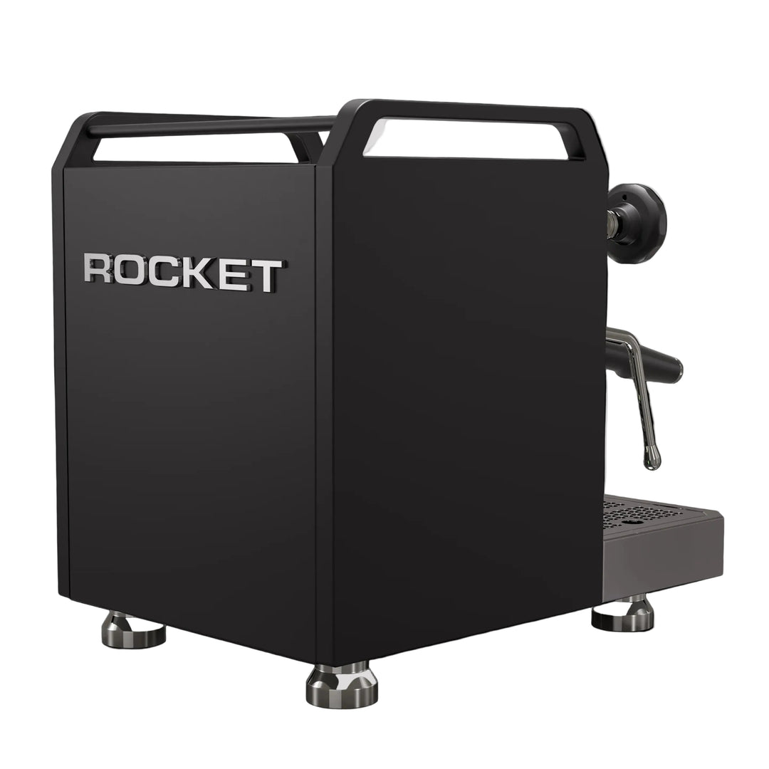 A matte black Rocket espresso machine with silver metallic accents, including the brand name 'ROCKET' on the front, set against a solid black background.