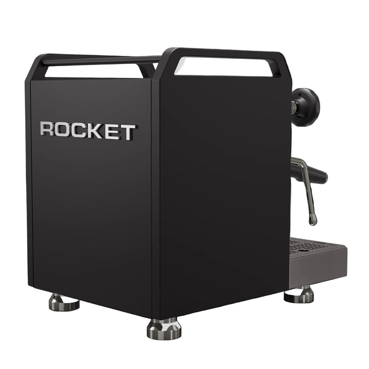 A matte black Rocket espresso machine with silver metallic accents, including the brand name 'ROCKET' on the front, set against a solid black background.