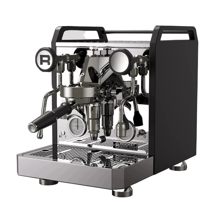 A professional espresso machine with a black side panel and polished stainless steel body, featuring a portafilter, steam wands, gauges, and drip tray, shown against a solid black background.