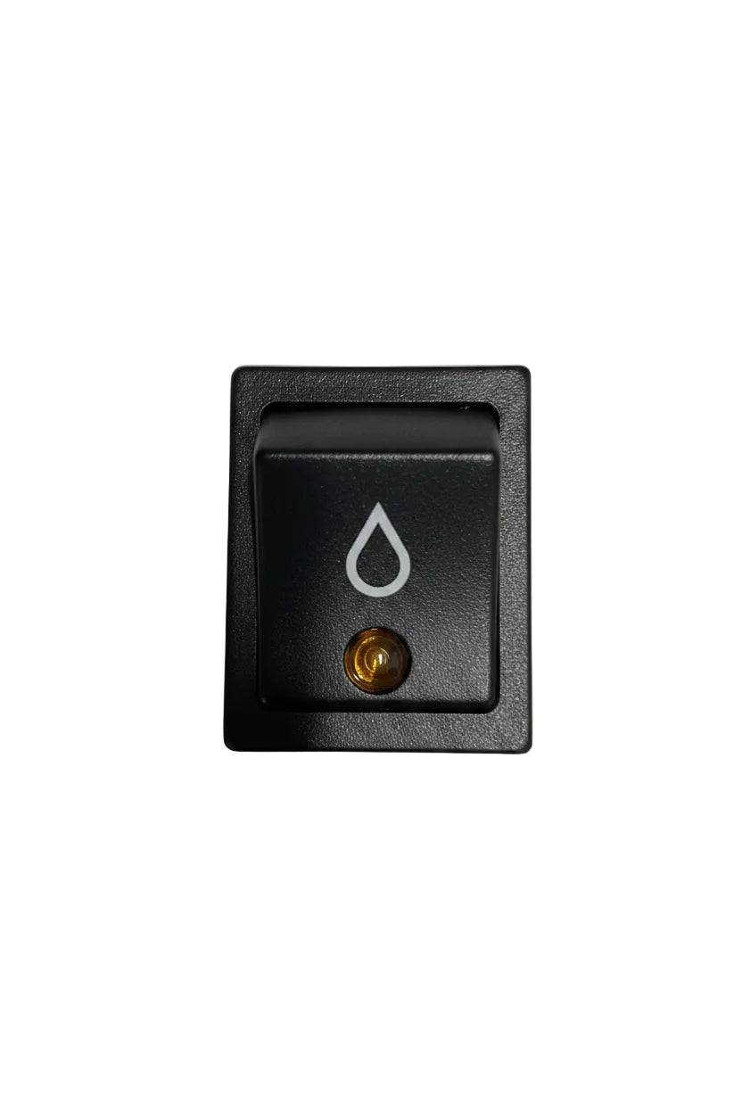 A square black rocker switch with a recessed button featuring a white droplet symbol and a small gold screw terminal, photographed on a plain off-white surface.