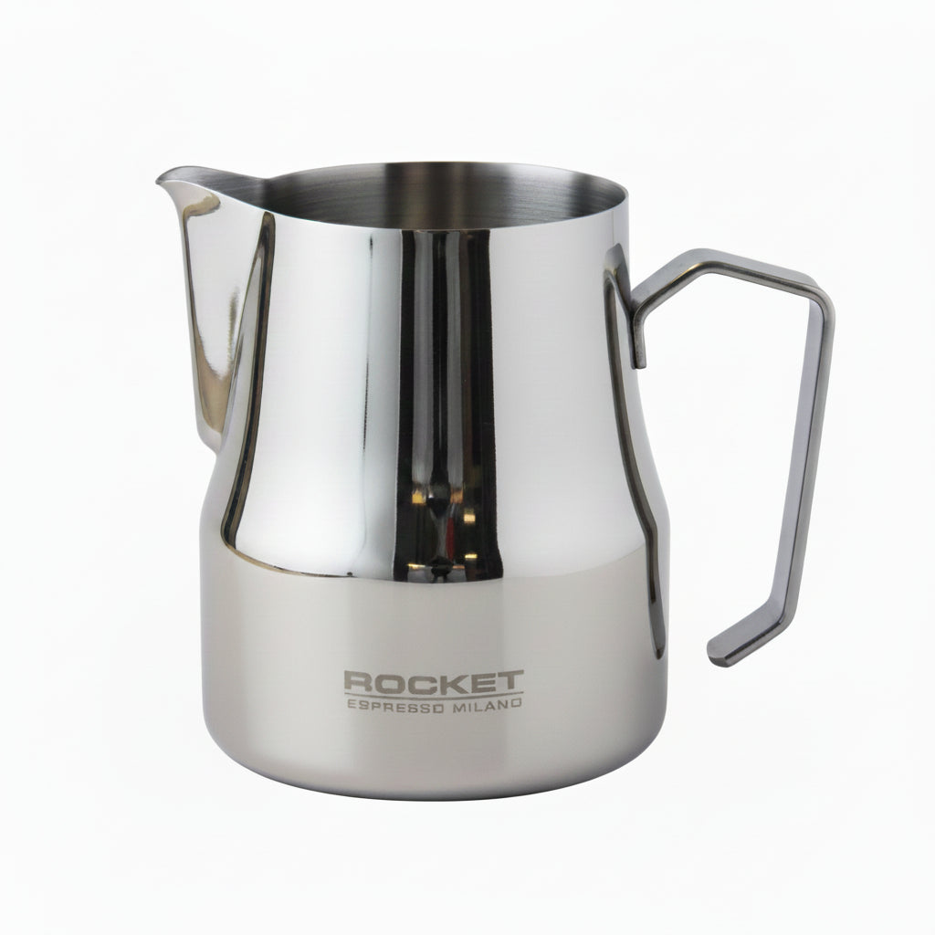 A polished stainless steel milk pitcher with a built-in handle and spout, featuring the 'ROCKET ESPRESSO MILANO' logo printed on the lower front, set against a neutral light gray background.