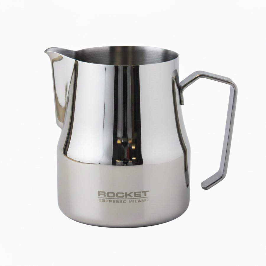 A polished stainless steel milk pitcher with a built-in handle and spout, featuring the 'ROCKET ESPRESSO MILANO' logo printed on the lower front, set against a neutral light gray background.